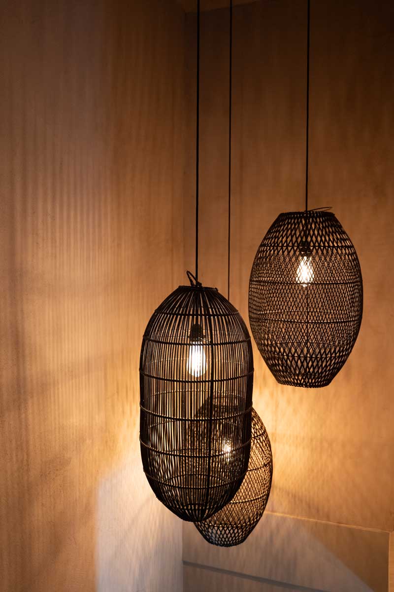 Woven pendant lights on a warm wall